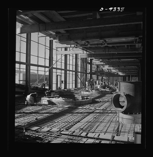 Production. Magnesium. High above the Nevada desert workmen lay reinforcing steel for the concrete floor of one of the 360-foot-long chlorination buildings at Basic Magnesium's huge plant near Las Vegas