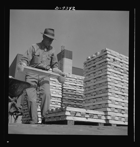 Production. Magnesium. Enormous asbestos mittens must be worn by men handling the thousands of hot magnesium ingots produced daily at Basic Magnesium's giant plant in the southern Nevada desert. A number of units of this plant are now in production. Full operation is scheduled for the summer of 1943