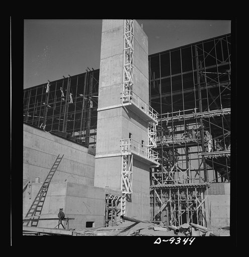 Production. Magnesium. A year ago this location was the barren desert of southern Nevada. Today an industrial city teams with the activities of over 12,000 workers as tons of steel and concrete give rise to the giant plant of Basic Magnesium. This exhaust tower, ninety feet high, with a portion of a