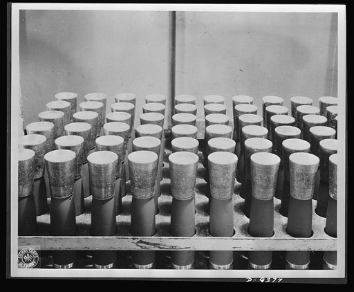 Production. Shell loading. TNT is poured into shells through these funnels on a distribution line in a large Midwest loading plant. TNT, used almost exclusively in shells, looks like a good grade of maple sugar. It is believed that soon the United States will use only TNT in bombs also. Ravenna ordn
