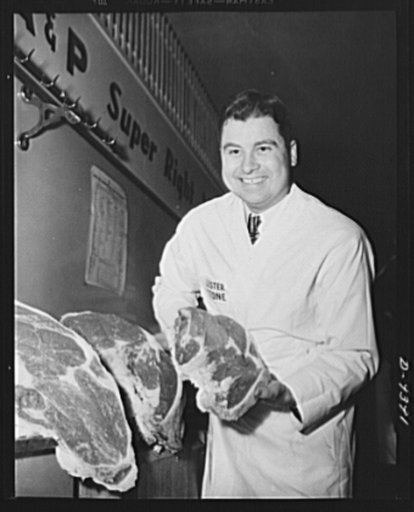 Meat rationing preview. "Price list" in terms of points but good to look at. Office of Price Administration (OPA) official shows choice cuts at meat rationing trial shopping