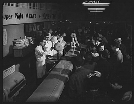 Meat rationing preview. Washington correspondents and their wives try out point shopping for meat with Office of Price Administration (OPA) rationing executives behind the counter