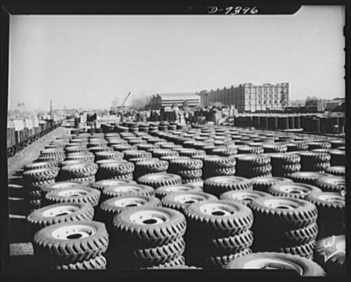 Indian rubber. Tires for the machines of war are part of the great stock pile of equipment at an Indian port city. Much of this material has been shipped to India by lend-lease. Barrage balloons protect the stockpile
