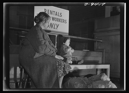War housing needs. The end of a long day's search for a place to live finds this seaman's wife and child at the war housing center in San Francisco, waiting for accommodations. Aid to stranded families such as this will come only when unused rooms in private homes are made available to war workers a