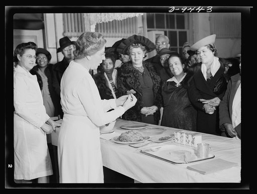 Wartime food demonstration. Explaining methods of "extending" meats now that rationing is limiting civilian meat purchases, wartime food demonstrator Alice Burtis puts finishing touches to a meat loaf before an audience in Washington, D.C.