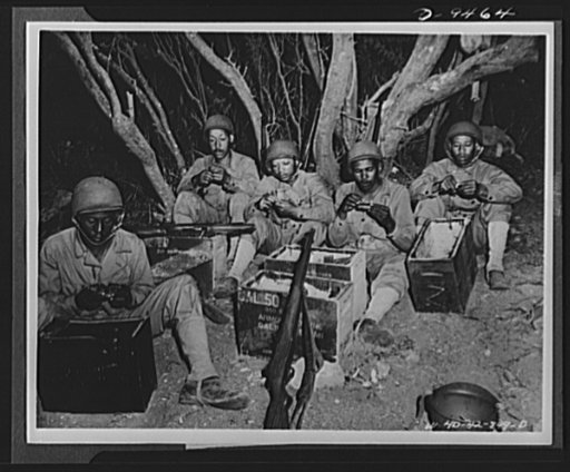 With an airfield security detachment in Hawaii. Constant practice keeps the troops alert at an airfield security post in Hawaii. Shown loading clips at Dusty Hollow Training Center there are, left to right: Private Moses Riley, Eastontown, Georgia; Private Lee Bullock, New York City; Private First C