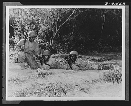 With an airfield security detachment in Hawaii. On the firing line at Dusty Hollow Training Center with an airfield security detachment in Hawaii are (left to right): Private Alfred Anderson, Algiers, Louisiana; Private Jack Golden, Marianna, Florida and Private First Class Edgar Martin, Macon, Geor