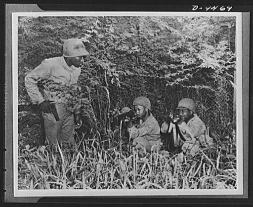 With an airfield security detachment in Hawaii. Kneeling and firing from cover is practiced regularly by an airfield security detachment at Dusty Hollow Training Center in Hawaii. Shown left to right are: Private Robert L. Rogers, Abbeville, Georgia; Private Harry Frank Anniston, Alabama