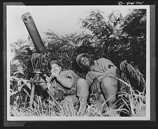 With an airfield security detachment in Hawaii. Manning a machine gun under cover are two members of an airfeild security detachment in Hawaii. Left to right are: Corporal Alvin J. Comeaux, Lafayette, Louisiana, and Corporal Ellis Smith, Birmingham, Alabama