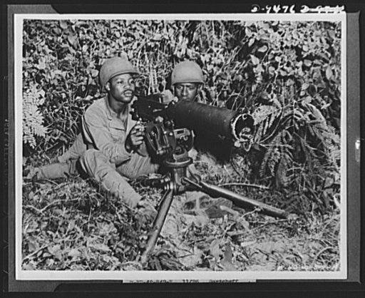 With an airfield security detachment in Hawaii. Familiarity with the operation of every part of a self-propelled 75 mm. gun is a "must" for the members of the gun crews of an airfield security detachment in Hawaii. Shown giving the gun close study are (left to right): Corporal Bonnie Hughes, Dallas,