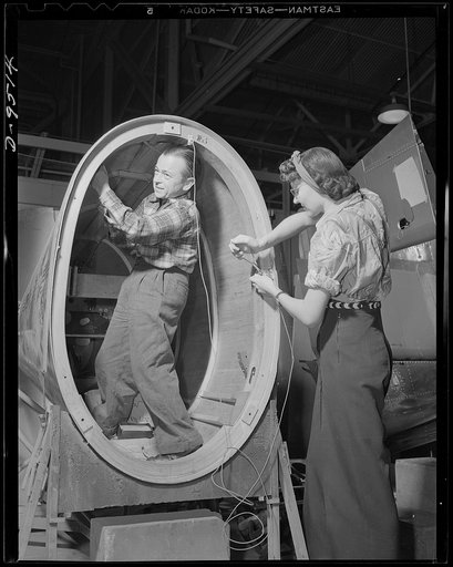 Production. BT-13A ("Valiant") basic trainers. A midget and a woman worker install control wires on a "Valiant" basic trainer at Vultee's Downey, California plant. At the Downey plant is made the BT-13A ("Valiant") basic trainer--a fast, sturdy ship powered by a Pratt and Whitney Wasp engine