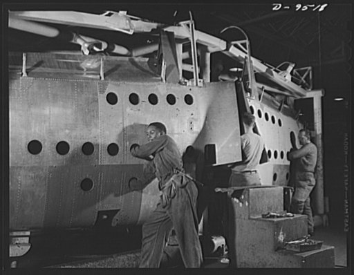 Production. BT-13A ("Valiant") basic trainers. Negroes work alongside white men on wing assemblies for "Valiant" basic trainers at Vultee's Downey, California plant. At the Downey plant is made the BT-13A ("Valiant") basic trainer--a fast, sturdy ship powered by a Pratt and Whitney Wasp engine