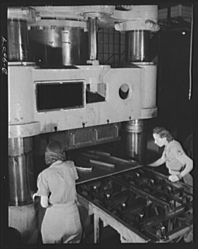 Production. A-31 ("Vengeance") dive bombers. Forming on the hydro press. Forming of metal parts for the "Vengeance" dive bombers in the huge hydro press at Vultee's Nashville Division. Here are two women engaged in an unusual job. The "Vengeance" (A-31) was originally designed for the French. It was