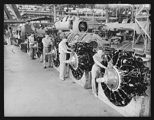 Production. A-31 ("Vengeance") dive bombers. Spark-plug installation. Workers are installing spark plugs in the powerful Wright "double cyclone" engine used in the Vultee "Vengeance" dive bomber manufactured at Vultee's Nashville Division. Note the partially completed "Vengeance" in the background. 