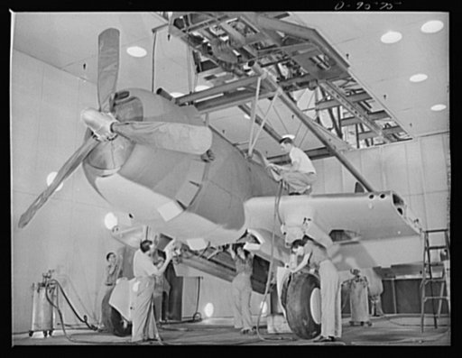 Production. A-31 ("Vengeance") dive bombers. Camouflaging the ship. A Vultee "Vengeance" dive bomber manufactured at Vultee's Nashville Division is shown attached to the overhead mechanized assembly line trolly. The dive bomber has just entered the huge paint spray booth where it is receiving its ca