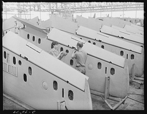 Production. A-31 ("Vengeance") dive bombers. Flap installation. This pair of workers are adjusting a flap installation on the outer wings upon arrival from the sub-contractor's plane prior to installation on the Vultee "Vengeance" dive bombers manufactured at Vultee's Nashville Division. The "Vengea