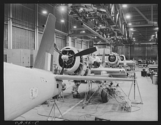 Production. A-31 ("Vengeance") dive bombers. Company inspection. Looking toward the rear of the final assembly line showing the "Vengeance" dive bombers made at the Nashville Division of Vultee Aircraft Inc., and suspended on the overhead mechanized assembly line, company inspectors are shown checki