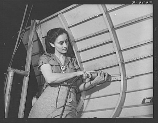 Production. A-31 ("Vengeance") dive bombers. Drilling rivet holes in the side panel of the aft monocoque. Using a hand drill, the young woman in this scene is drilling rivet holes in the side panel of the aft monocoque, a step in the fabrication process of manufacturing Vultee "Vengeance" dive bombe