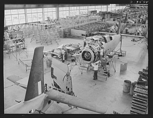 Production. A-31 ("Vengeance") dive bombers. Motor installation. A high angle view of a group of workers installing the motor on a Vultee "Vengeance" dive bomber at the Nashville Division of Vultee Aircraft Inc. Note that the inner wings are ready to be attached at this point. The "Vengeance" (A-31)