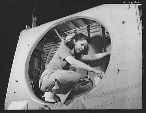 Production. A-31 ("Vengeance") dive bombers. Landing gear installation. This woman worker at Vultee-Nashville is shown making final adjustments in the wheel well of an inner wing before installation of the landing gear. This is one of the numerous assembly operations in connection with the mass prod