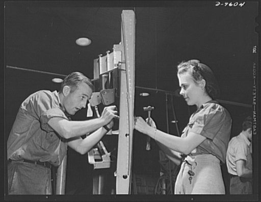 Production. A-31 ("Vengeance") dive bombers. Side panel section assembly. Two workers at the Nashville Division of Vultee Aircraft Inc. are pictured here working on a side panel section assembly, one of the steps in the construction of Vultee "Vengeance" dive bombers. The "Vengeance" (A-31) was orig