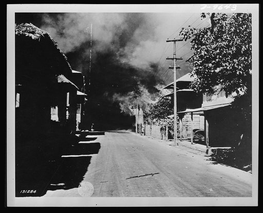 General view showing houses burning as the result of Japanese bombing raid in Bataan, the Philippine Islands