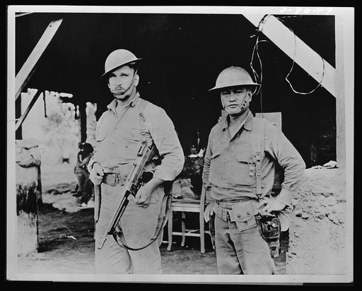 Brothers in arms. Typical of the 10,000 Americans who helped to stall Japan's forces on Bataan was Captain Arthur W. Wermuth (left) shown here with his Filipino aide. During the four months of fighting in Bataan, Captain Wermuth and his aide accounted for over a hundred of the enemy