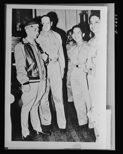 President Manuel L. Quezon is shown conferring with General Douglas MacArthur and members of his staff, during the fighting in the Philippines