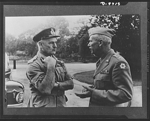 Behind scenes with generals as they mapped woe for Axis. Caught in earnest discussion, Field Marshal Sir Archibald Wavell, commander-in-chief, India, flexes his arm as he chats with Lieutenant General Brehon Somervell, chief of the entire U.S. Army, Service of Supply