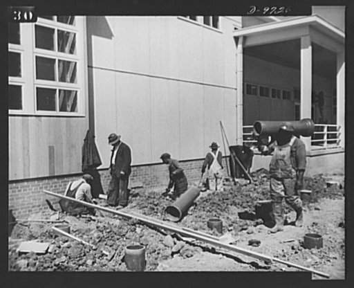 Latest addition to D.C. War Housing Program. Mechanics laying pipe at Wake and Midway Halls, latest addition to the housing for war workers in Washington, D.C. The new buildings will house 1,000 Negro women war workers and is being completed by Samuel Plato, contractor