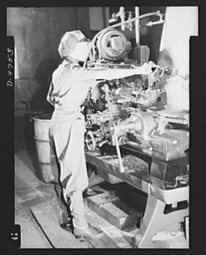 Safe clothes for women war workers. Safely and becomingly dressed in her washable denim uniform, Eunice Kimball operates a horizontal milling machine at the Bendix Aviation Plant, turning out essential parts for the armed forces with no danger of accident from a dangling necklace, a loose wisp of ha
