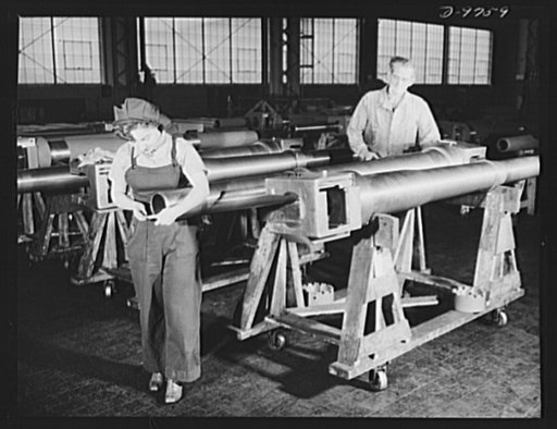 Production. 105 mm. howitzers. Dorothy Conger and Earl A. Ross, U.S. ordnance inspectors, checking over 105 mm. howitzers in the plant of Chain Belt Company, Milwaukee, Wisconsin