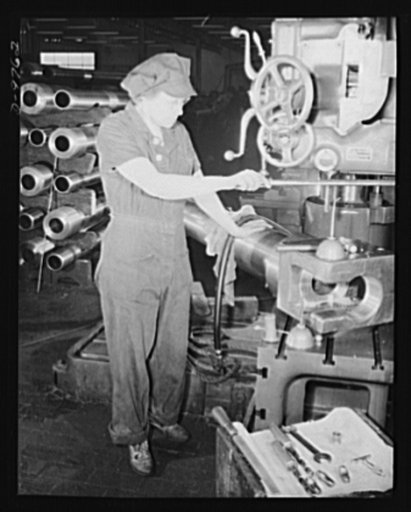 Production. 105 mm. howitzers. Mrs. Florence Ritter performing a drilling operation on a 105 mm. howitzer at the Milwaukee, Wisconsin plant of Chain Belt Company. Her husband and son-in-law are in the Army