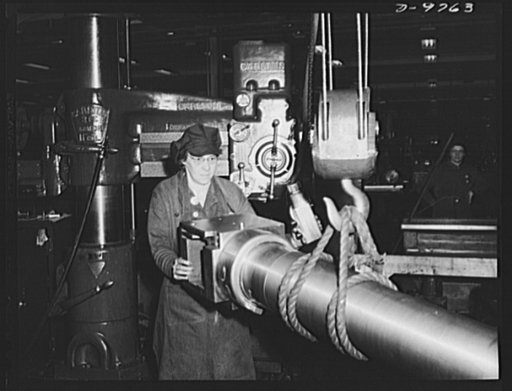 Production. 105 mm. howitzers. Mrs. Florence Ritter removing a 105 mm. howitzer from a drilling machine at the Milwaukee, Wisconsin plant of Chain Belt Company