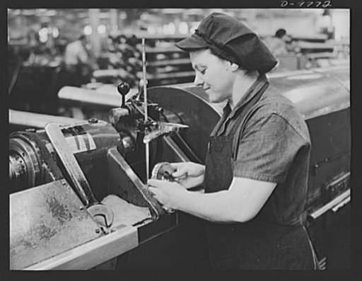 Production. 105 mm. howitzers. Mrs. Mary Betchner inspecting one of the twenty-five cutters for burrs before inserting it in the inside of a 105 mm. howitzer in the Milwaukee, Wisconsin plant of Chain Belt Company. Her son is in the Army; her husband and daughter are in war work