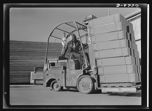 Women in essential services. Ethel Peterson, twenty-seven, an expert lift-truck operator at the Paraffine Company in Emeryville, California. Her job demands manual skill and excellent driving judgement, for sharp curves must be rounded and the cargo must be handled with precision and speed at all ti