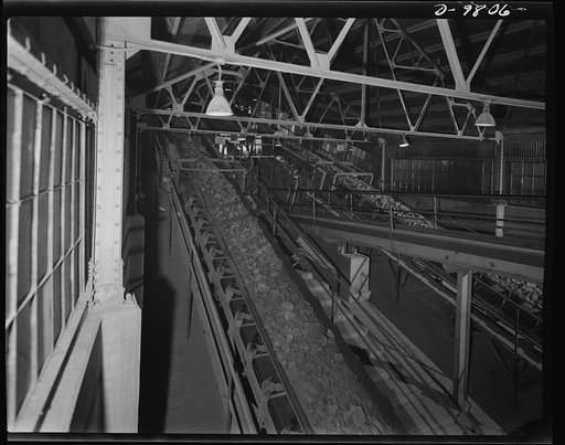 Production. Copper. Copper ore travelling on belt conveyors at one of the large copper concentrators of the Utah Copper Company. The Utah Copper Company iron detectors straddling the conveyors automatically stop the operation when tramp iron is detected in the ore
