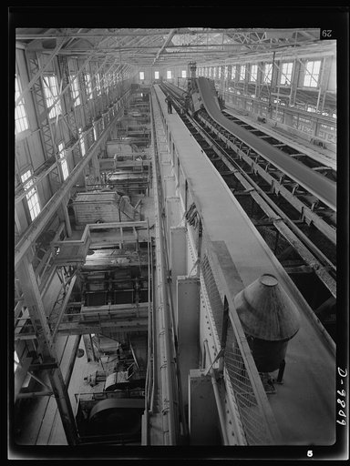 Production. Copper. Fine copper ore travelling on a conveyor belt which discharges the ore into bins at one of the concentrators of the Utah Copper Company at Magna and Arthur in Utah. Vast quantities of the copper so vital to the war effort are treated here