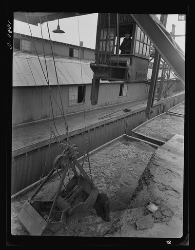 Production. Copper. Unloading copper concentrates with a clamshell bucket at the Garfield, Utah smelter of the American Smelting and Refining Company. The concentrates were produced at the Magna and Arthur mills of the Utah Copper Company