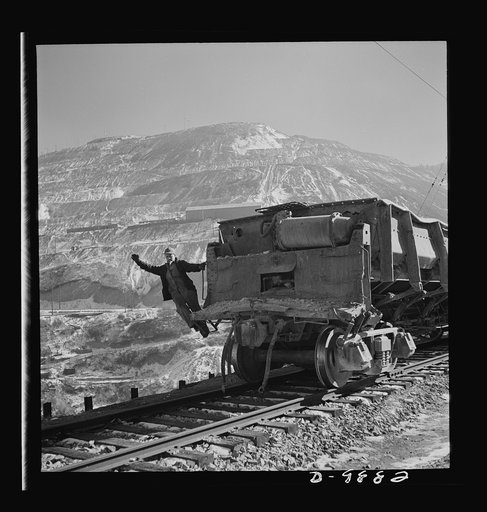 Utah Copper: Bingham Mine. Brakeman of an ore train at the open-pit mining operations of Utah Copper Company, at Bingham Canyon, Utah