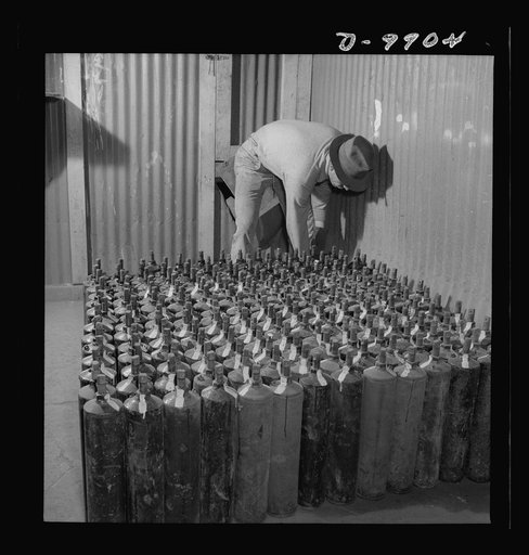 Production. Mercury. Filling flasks of triple-distilled mercury at a New Idria, California extraction plant. Each flask contains seventy-six pounds of mercury. Triple-distilled mercury is produced here by the New Idria Quicksilver Mining Company from cinnabar, an ore containing sulfur and mercury, m