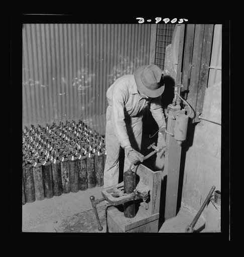Production. Mercury. Filling flasks of triple-distilled mercury at a New Idria, California extraction plant. Each flask contains seventy-six pounds of mercury. Triple-distilled mercury is produced here by the New Idria Quicksilver Mining Company from cinnabar, an ore containing sulfur and mercury, m