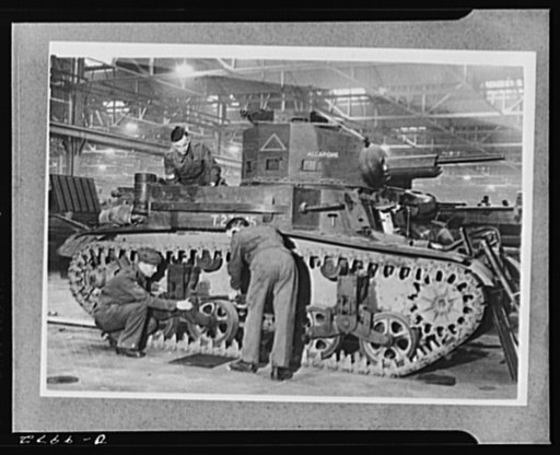 Lend-Lease to Britain. Fitters are at work assembling an American light tank which has just arrived at an English ordnance depot from the United States as part of a lend-lease shipment