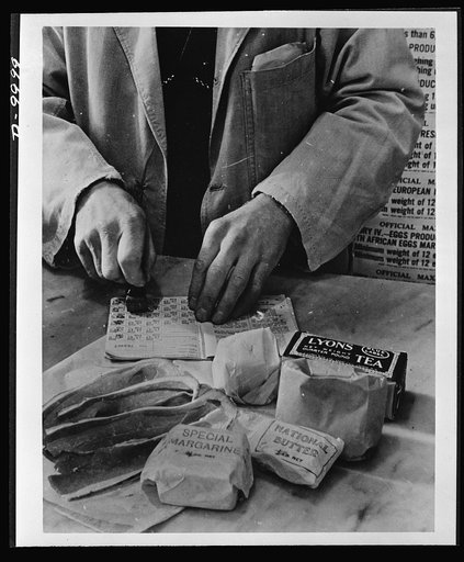 Food in England. A shopkeeper cancels the coupons in a British housewife's ration book for the tea, sugar, cooking fats and bacon she is allowed for one week. Most foods in Britain are rationed and some brand names are given the designation "National"