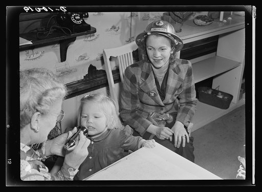 War workers' nursery. The morning checkup at modern nursery schools includes mouth and throat inspection. Mrs. Arlene Corbin, time checker at a Richmond, California shipyard waits until two-and-a-half-year-old Arlene is pronounced in perfect health by Mrs. Elsie Curran, supervisor at the Bella Vista