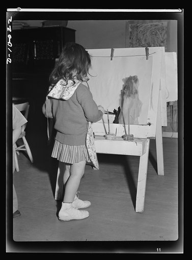 War workers' nursery. Children of war-working mothers find plenty to do in modern nursery schools. Painting with water colors is popular with young children