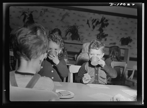 War workers' nursery. His milk and graham crackers, part of the Bella Vista Nursery School's afternoon schedule, do not seem to be totally occupying this young man's attention