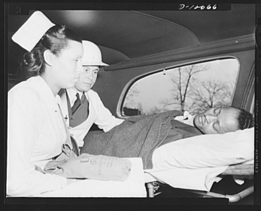 Office of Civilian Defense worker help protect nation's capital. After receiving first aid treatment in practice raid in Washington, D.C., air raid "victim" is removed to a hospital by a medical corps of the Office of Civilian Defense. Both the physician and nurse carry gas masks