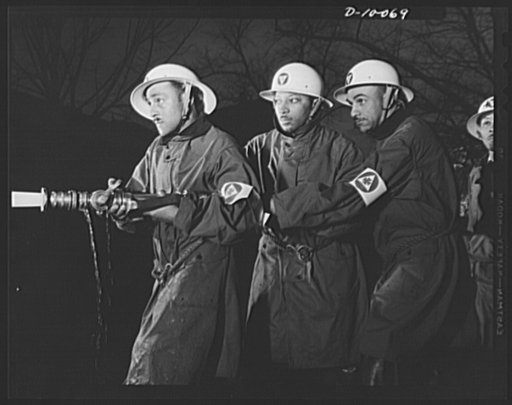 Office of Civilian Defense worker help protect nation's capital. Volunteer auxiliary firemen must learn to master the control of the water stream from their fire hoses. Certain conditions call for spray, others for a steady stream of water. These volunteers in Washington, D.C., are trained to know j