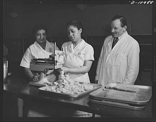 Cheese which had been dehydrated, then rehydrated, to be served at luncheon on March 11, 1943, at the Hotel Statler, Washington, D.C., in observance of the second anniversary of lend-lease, is sliced in the hotel kitchen. Some 750 guests were served